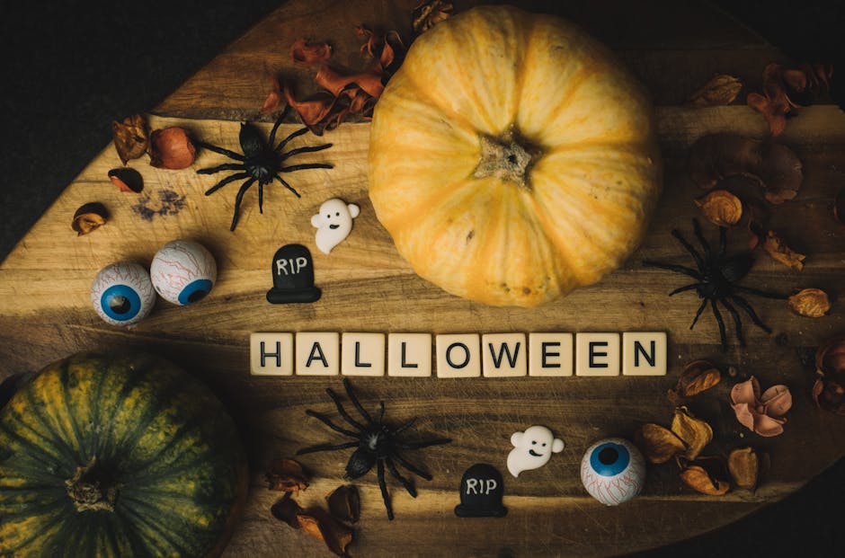 haunted attractions and Halloween theme parks - Halloween-themed flatlay featuring pumpkins, spiders, and eerie decorations on a wooden background.