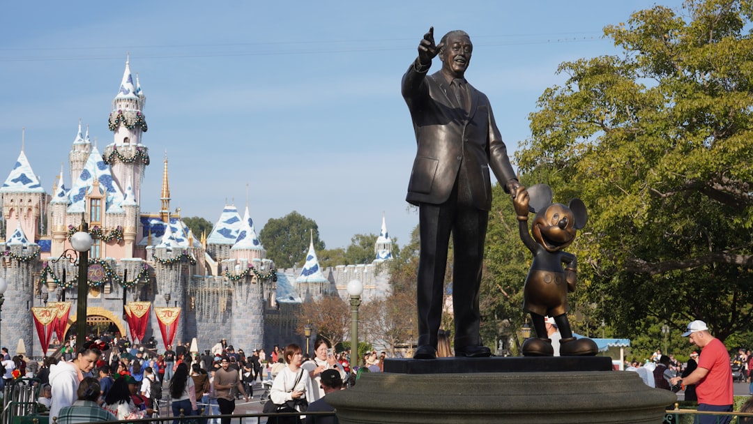 indoor vs outdoor theme parks - Partners statue with cinderella castle in background
