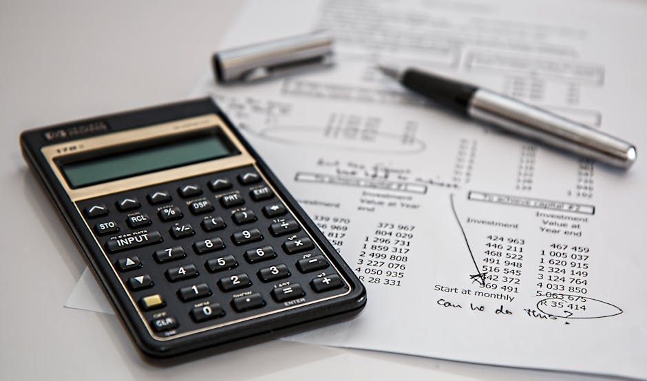 traveling to theme parks on a budget - Close-up of financial documents with calculator and pen, ideal for business management themes.