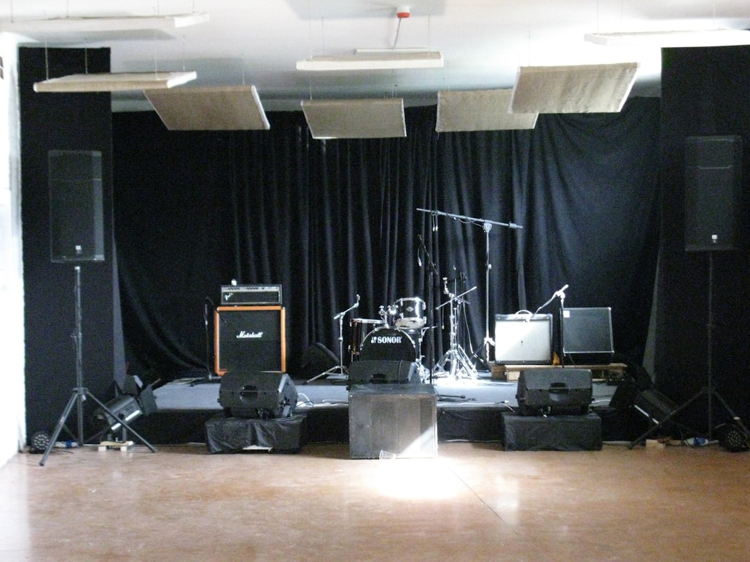 types of concert venues - a stage with speakers and a microphone