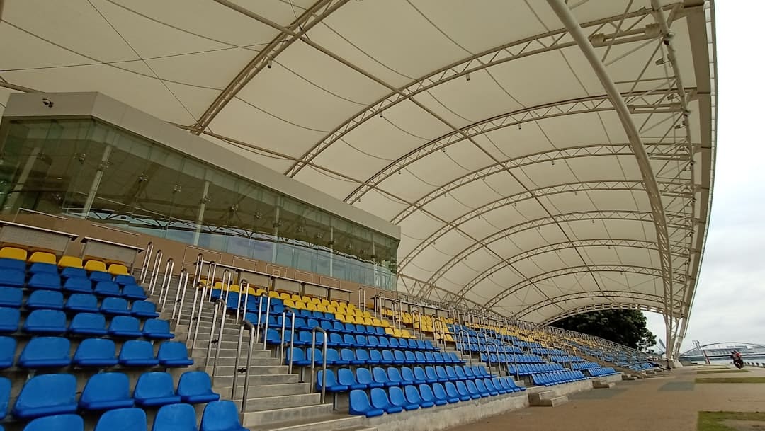types of sporting stadiums - a row of blue and yellow seats in a stadium