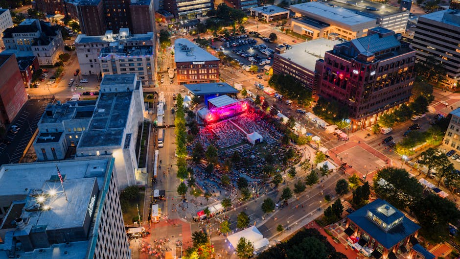 bonnaroo festival camping - Drone shot capturing a vibrant night festival in downtown Chattanooga, Tennessee.