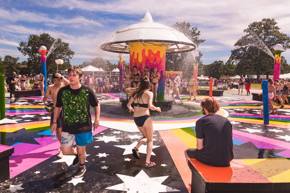 bonnaroo festival camping - People enjoying colorful water park on a sunny summer day, full of fun and laughter.