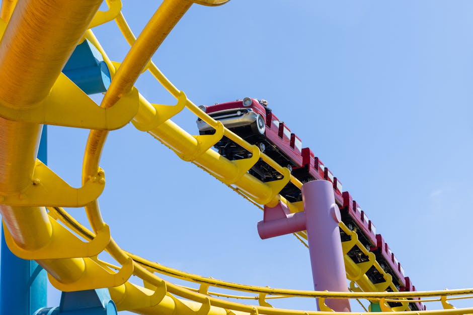 roller coaster inversions - Vivid roller coaster with vibrant tracks under a clear sky, evoking thrill and adventure.