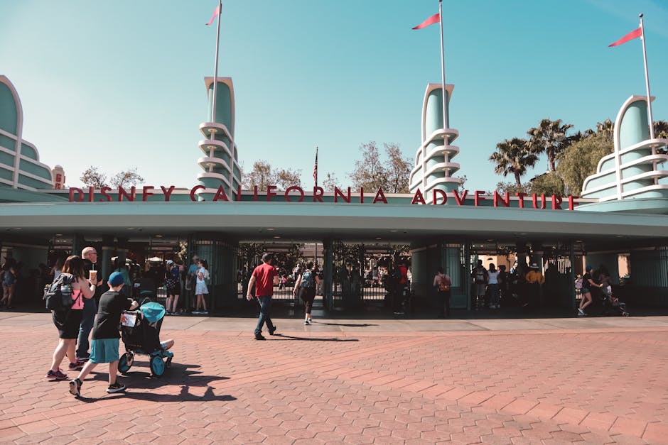 disneyland resort tips - Visitors at Disney California Adventure Park entrance in Anaheim, a popular family destination.