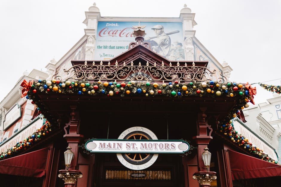 disneyland resort tips - A festive view of 'Main St. Motors' adorned with colorful baubles and holiday decor in Paris, France.