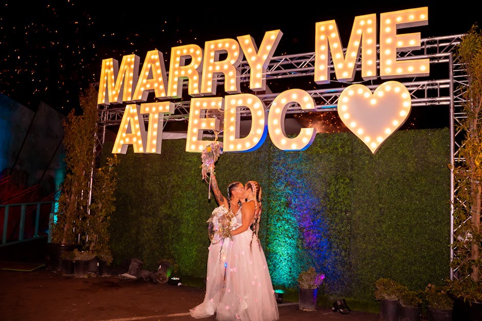 edc las vegas festival - A couple shares a kiss under a 'Marry Me at EDC' sign, amidst a magical setting.