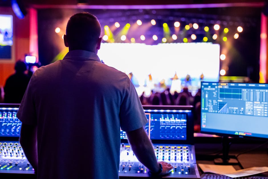 concert sound system - Audio engineer mixing live concert sound at a vibrant event.