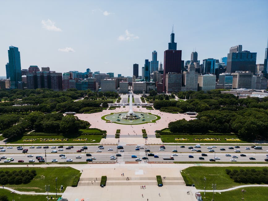 lollapalooza festival - Aerial view of Buckingham Fountain with Chicago skyline in the background, vibrant summer day.