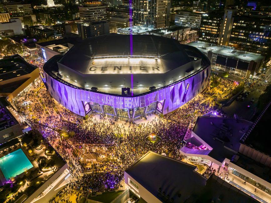 sports venues news - A vibrant night aerial view of Golden 1 Center in Sacramento, California during a lively event with a large crowd.