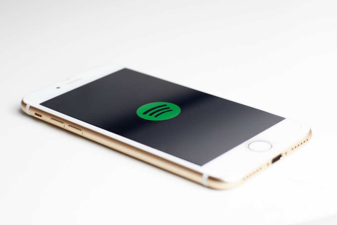live music news - gold iPhone 7 displaying spotify logo