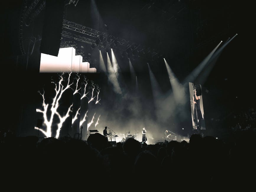 **weekly concert news** - Engaging night concert with lights, smoke, and audience in Amsterdam.