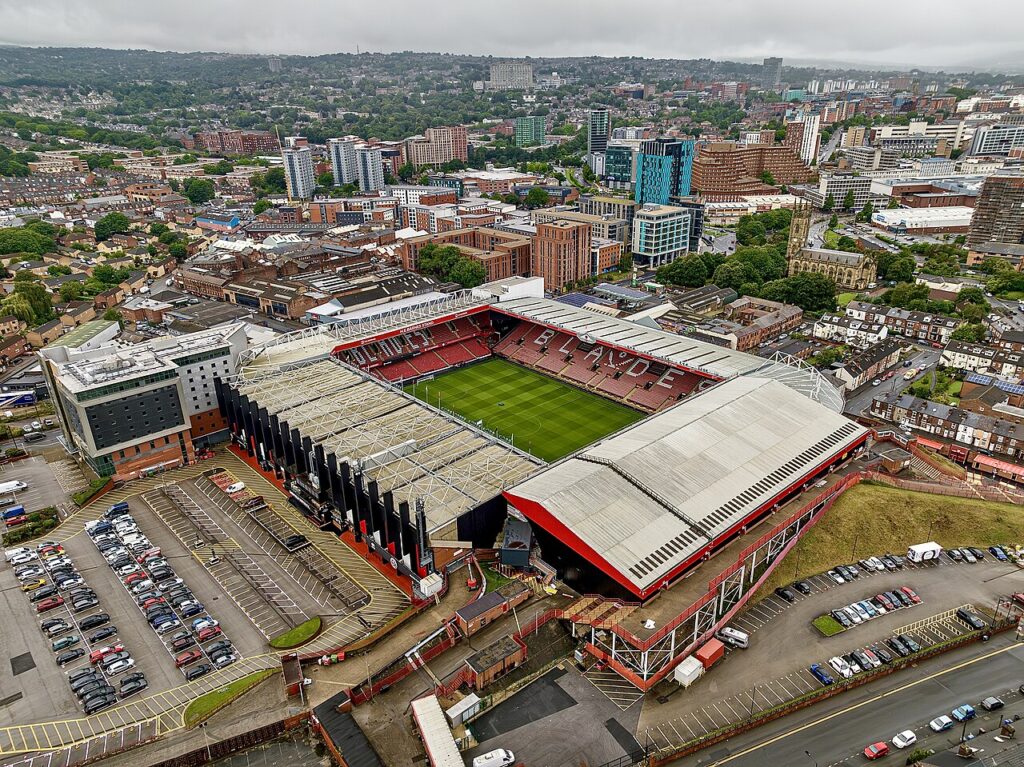 Aerial view of Bramall Lane stadium with the Sheffield skyline behind