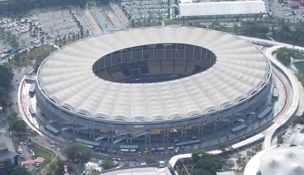 Aerial view of Bukit Jalil National Stadium in Kuala Lumpur showing its ring-shaped white membrane roof