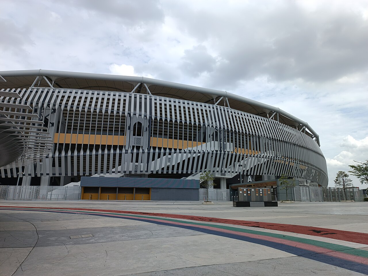 Exterior of Bukit Jalil National Stadium showing the twisted vertical louvre facade added for the 2017 SEA Games