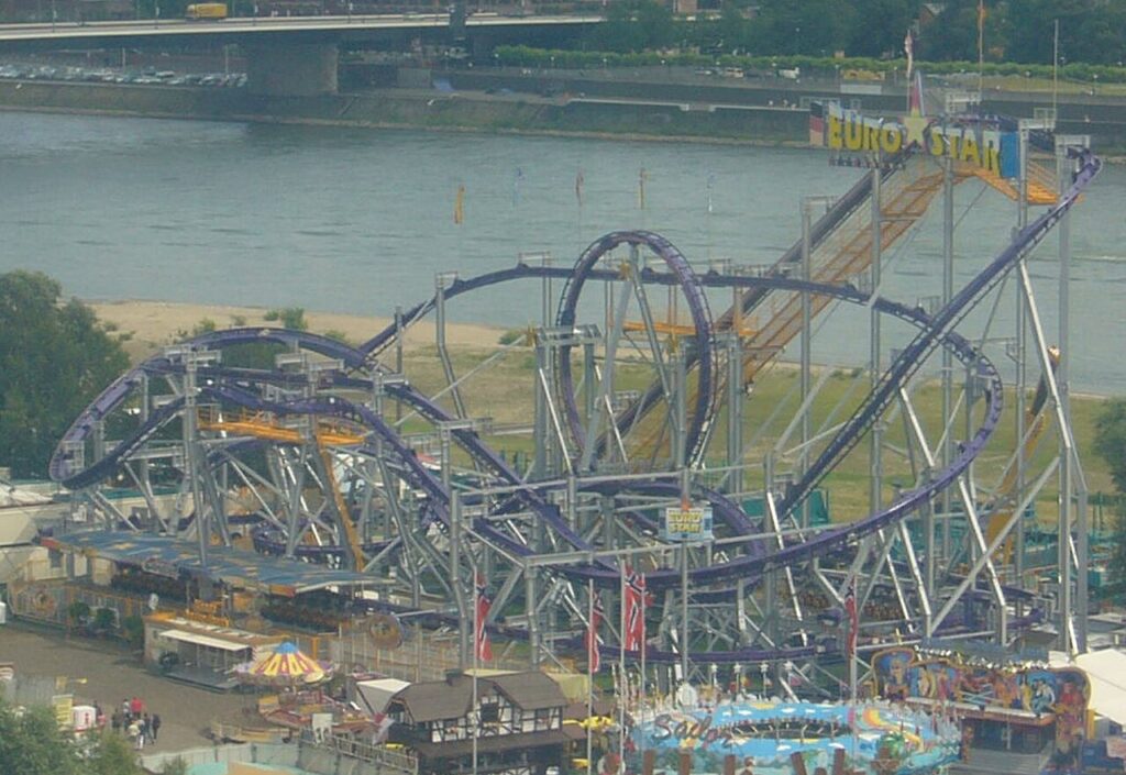 EuroStar inverted roller coaster with purple track set up at a fairground in Düsseldorf beside the Rhine in 2007