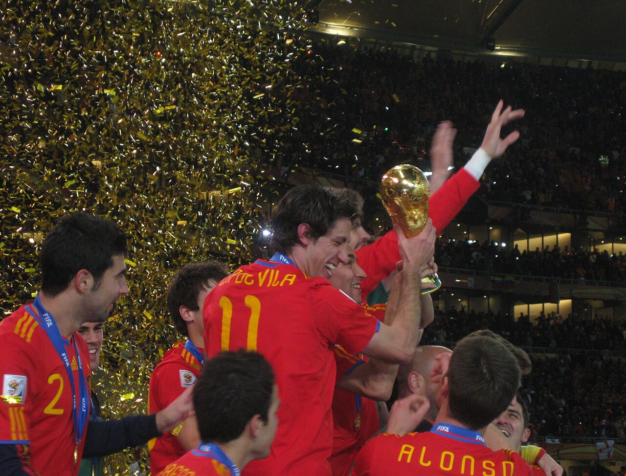 Spain celebrate with the World Cup trophy at FNB Stadium after beating the Netherlands in the 2010 final