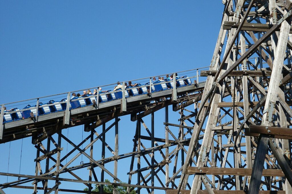 Blue Gemini train climbing the wooden-structure lift hill at Cedar Point