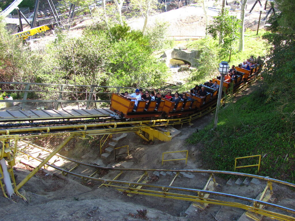 Gold Rusher mine train coaster riding through the hillside terrain at Six Flags Magic Mountain