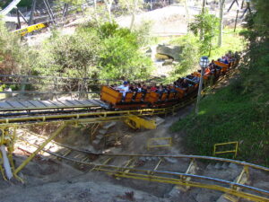 Gold Rusher mine train coaster riding through the hillside terrain at Six Flags Magic Mountain