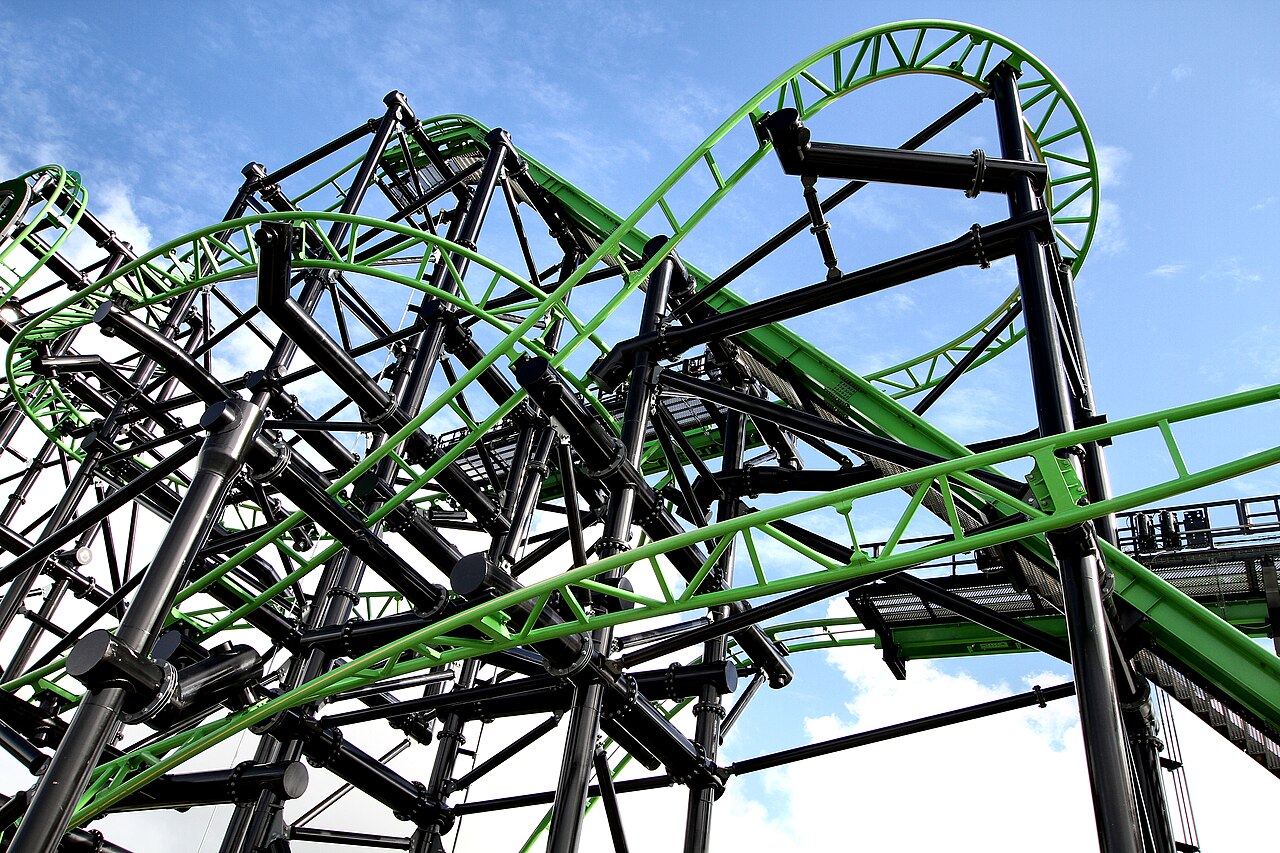 Looking up at Green Lantern Coaster's green track and black supports