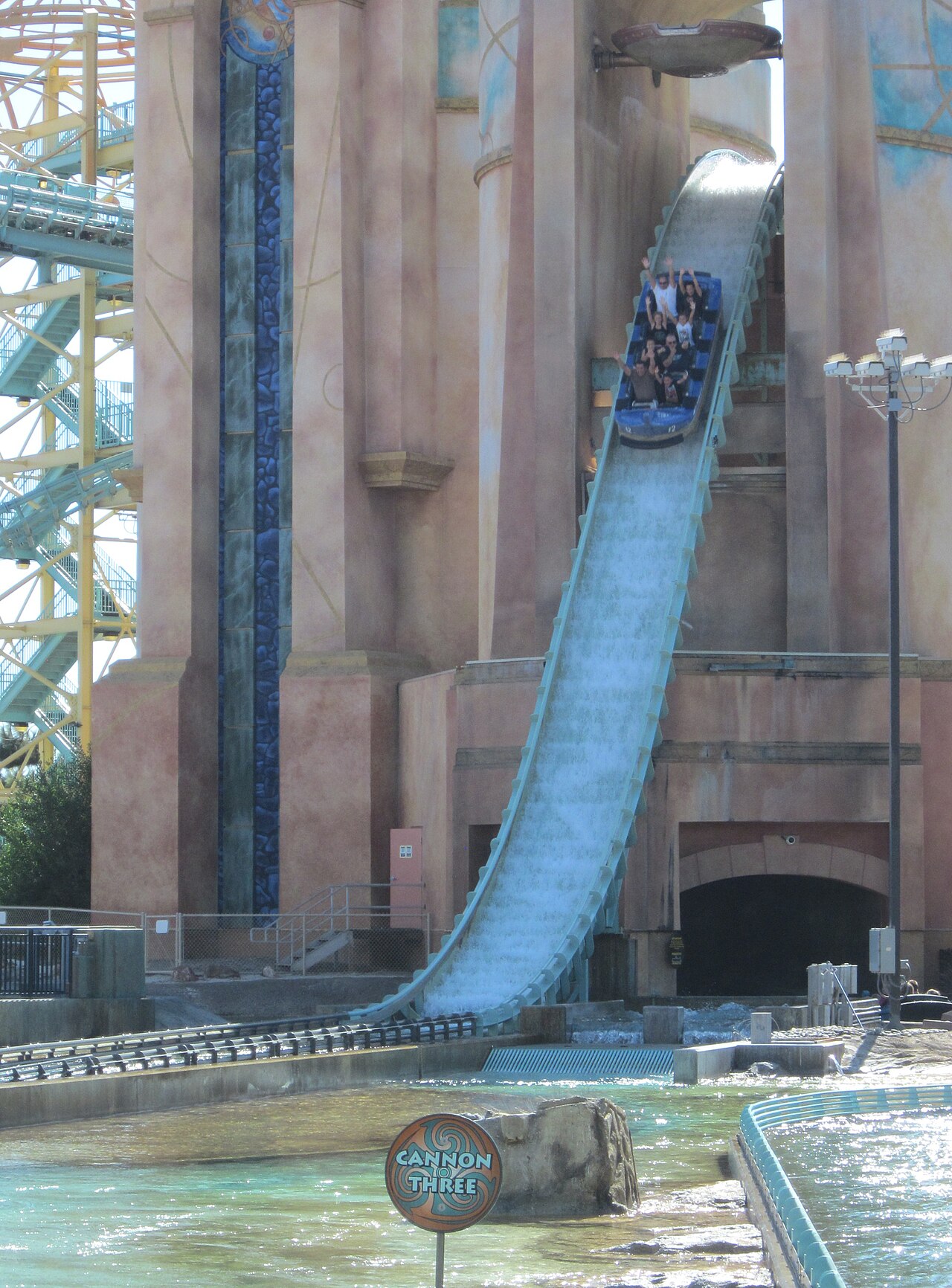 Boat full of riders descending the water-flooded drop out of the tower on Journey to Atlantis at SeaWorld San Diego