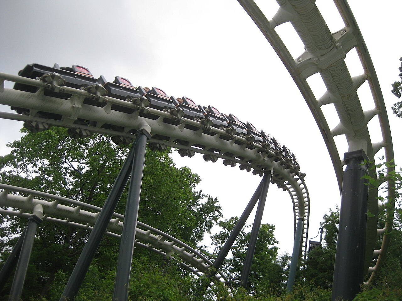 Lisebergbanan train sweeping through a banked curve on white track