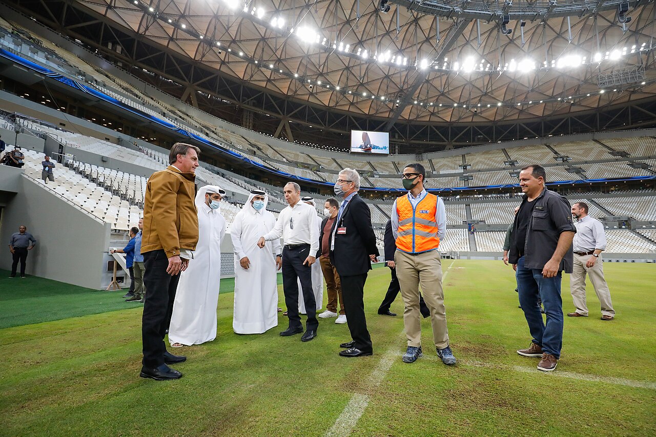 Interior of Lusail Stadium showing the pitch, seating bowl and saddle-shaped roof during a 2021 official visit
