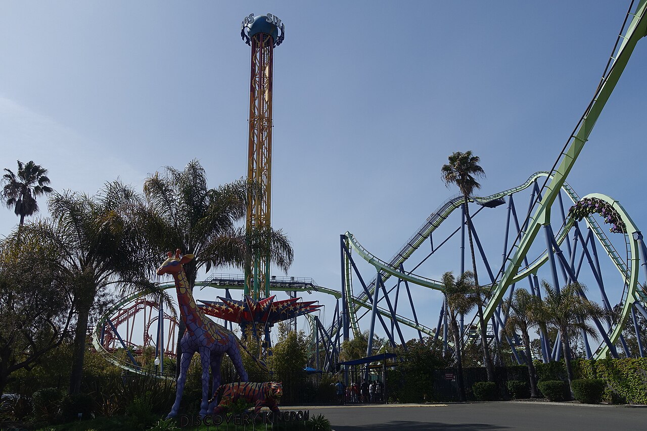 Medusa's green track and purple supports tower over the Six Flags Discovery Kingdom entrance area