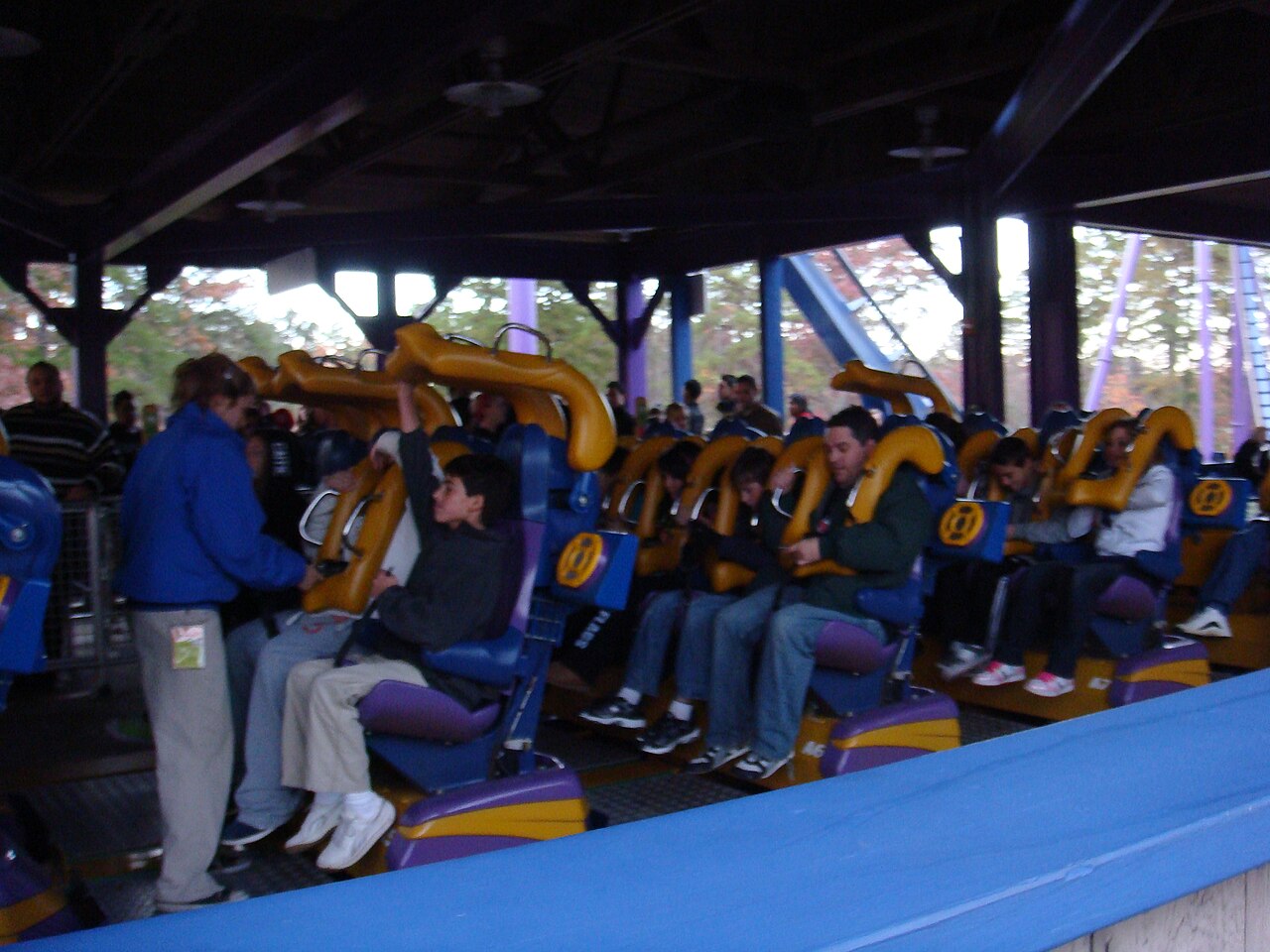 The Bizarro-era floorless train loading in the station with blue and purple theming