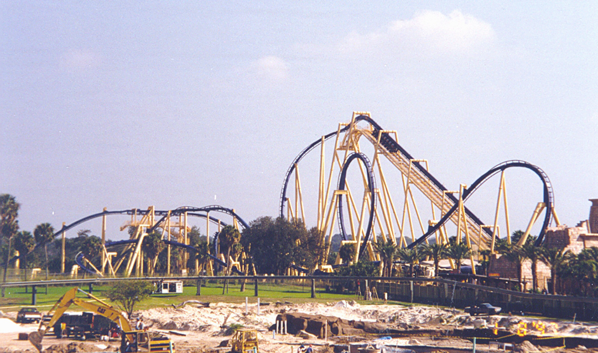 Full view of Montu's blue track, vertical loop and lift hill rising over the Egypt area of Busch Gardens