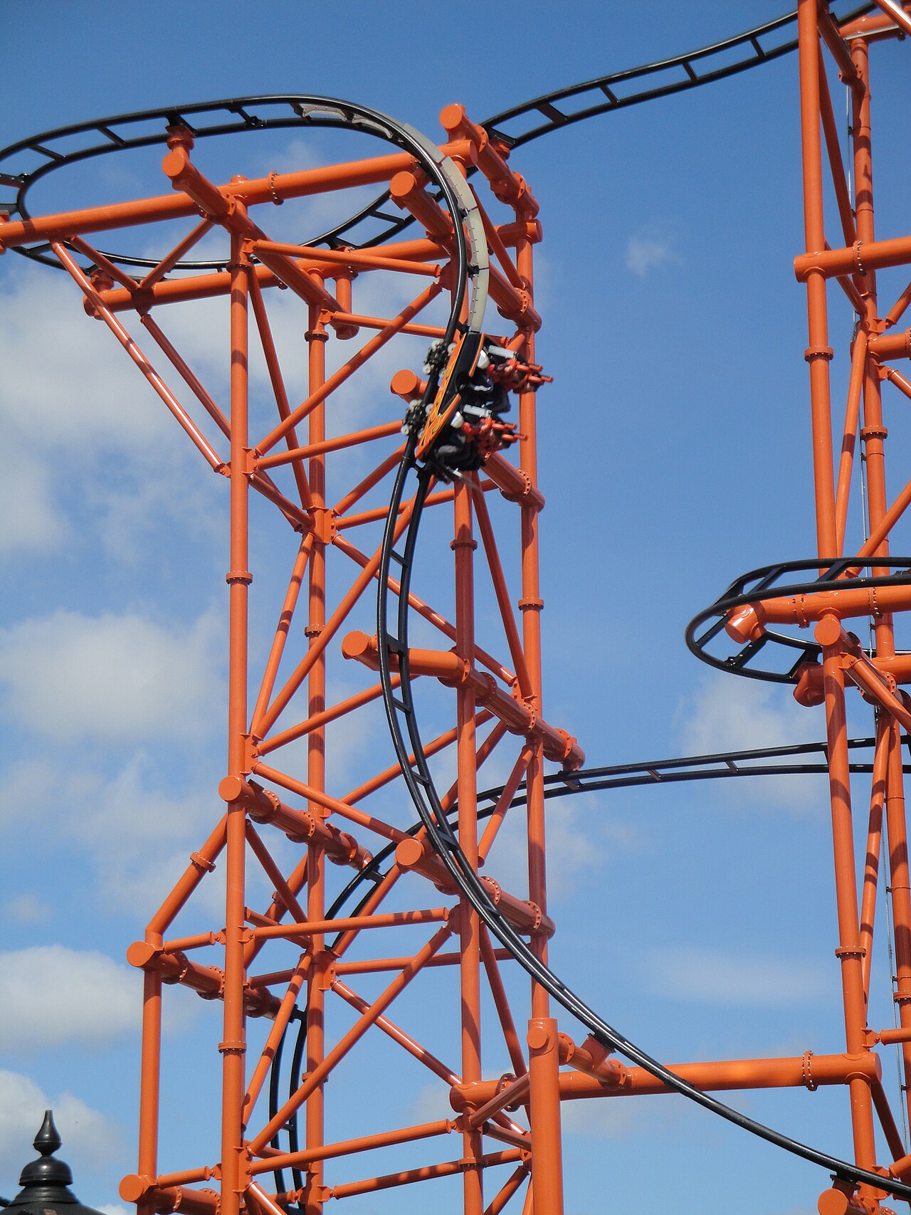 A Mumbo Jumbo car climbing the vertical lift on the coaster's orange structure at Flamingo Land