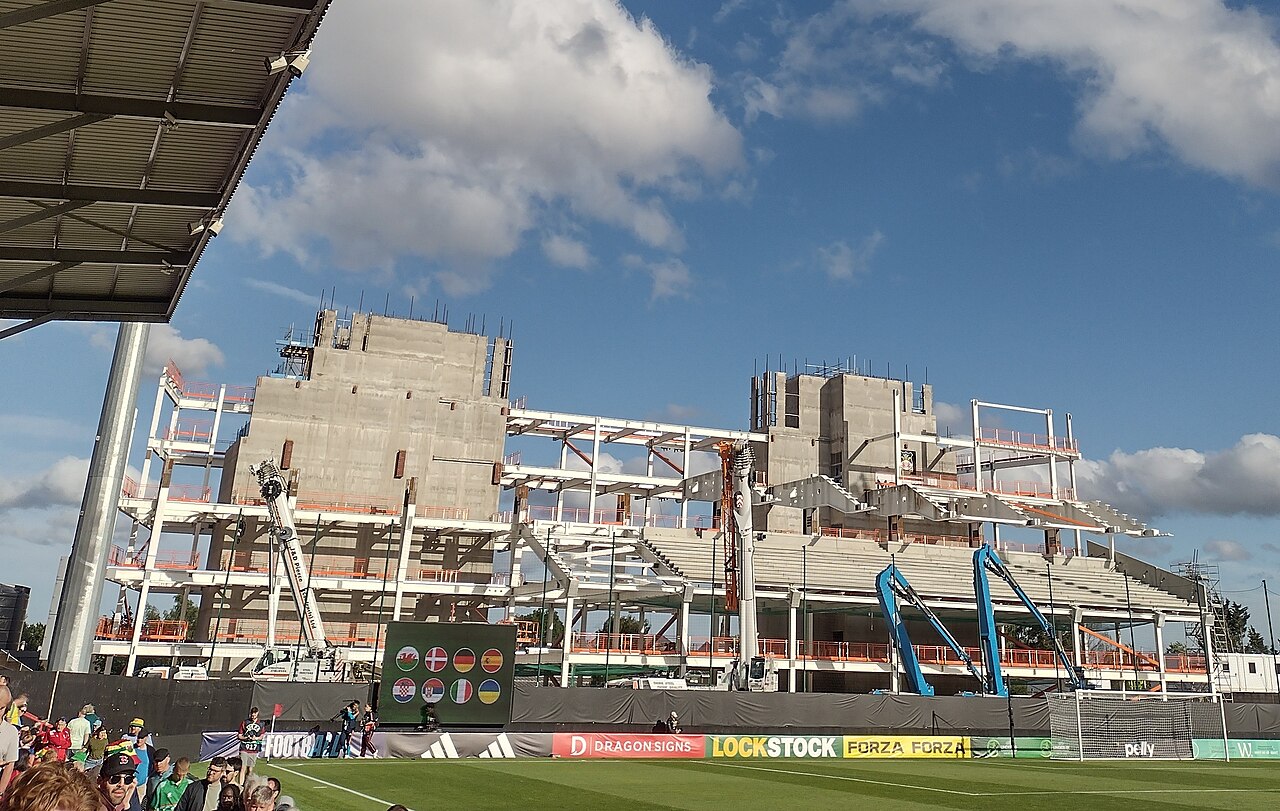 Steel and concrete frame of the new Kop Stand rising at the Racecourse Ground, Wrexham