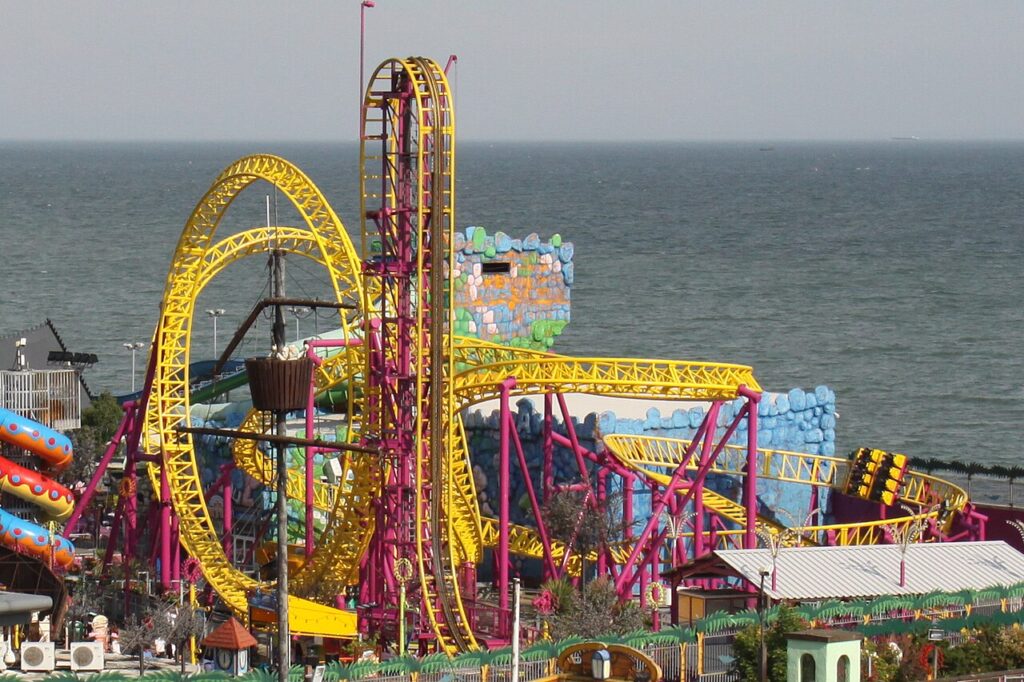 Rage roller coaster at Adventure Island, Southend-on-Sea, with its yellow track and pink supports beside the sea