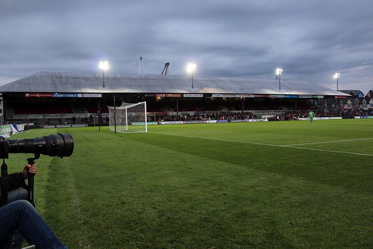 The west stand at Rodney Parade under floodlights