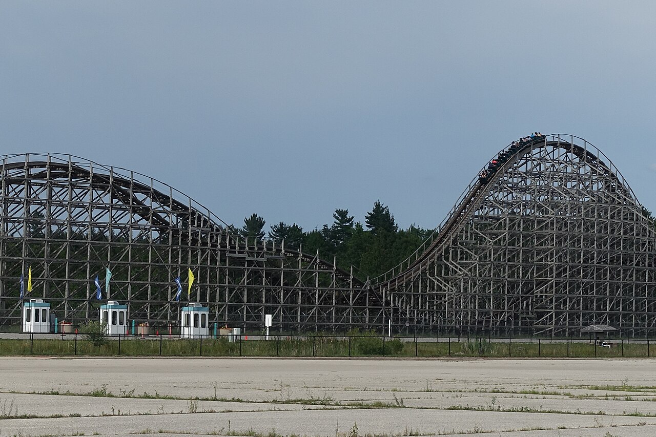 A train crests one of Shivering Timbers' back airtime hills at Michigan's Adventure