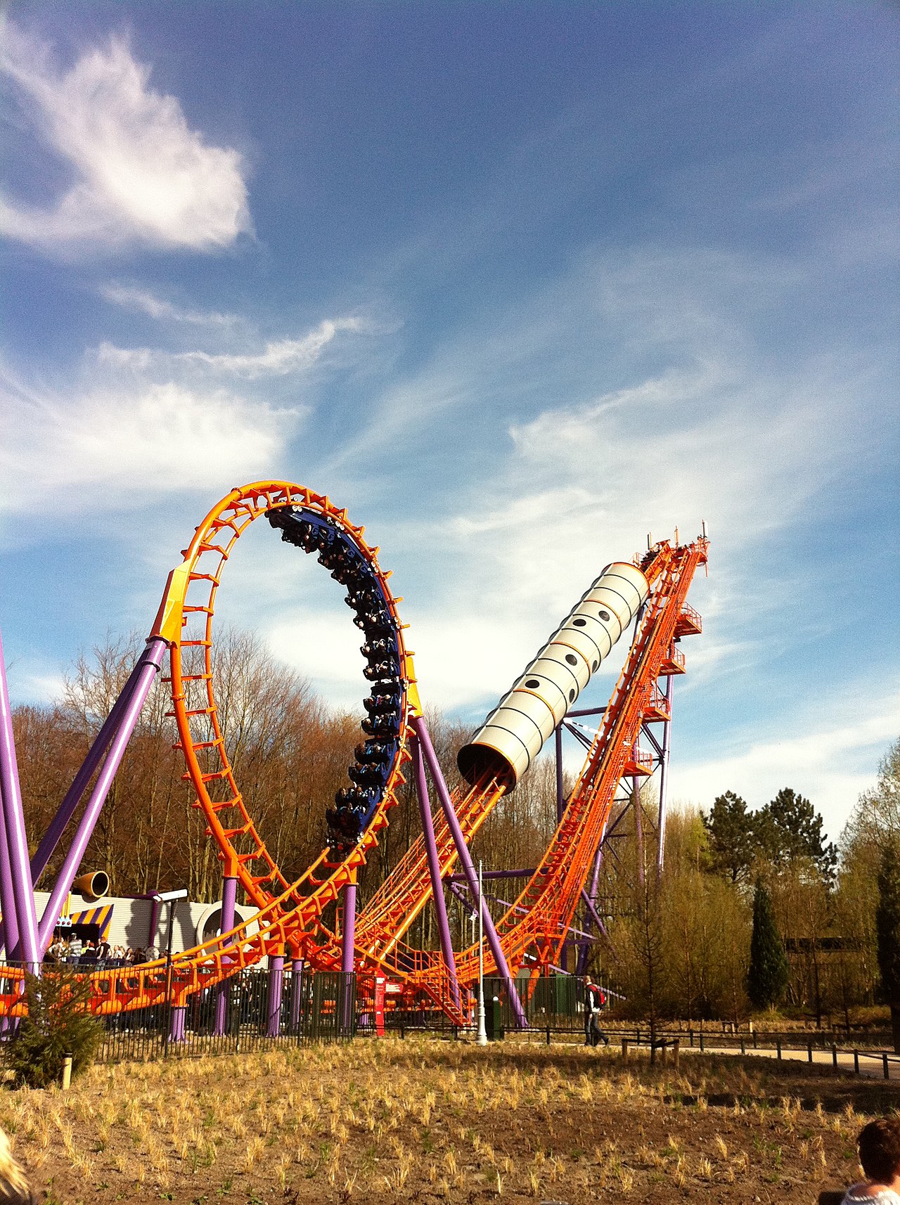 Speed of Sound's orange vertical loop with a train inverting and the rear lift spike behind at Walibi Holland