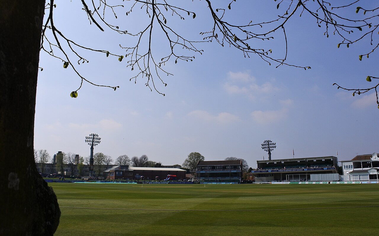 The St Lawrence Ground seen past the trunk of the replacement lime tree, with the Frank Woolley Stand beyond