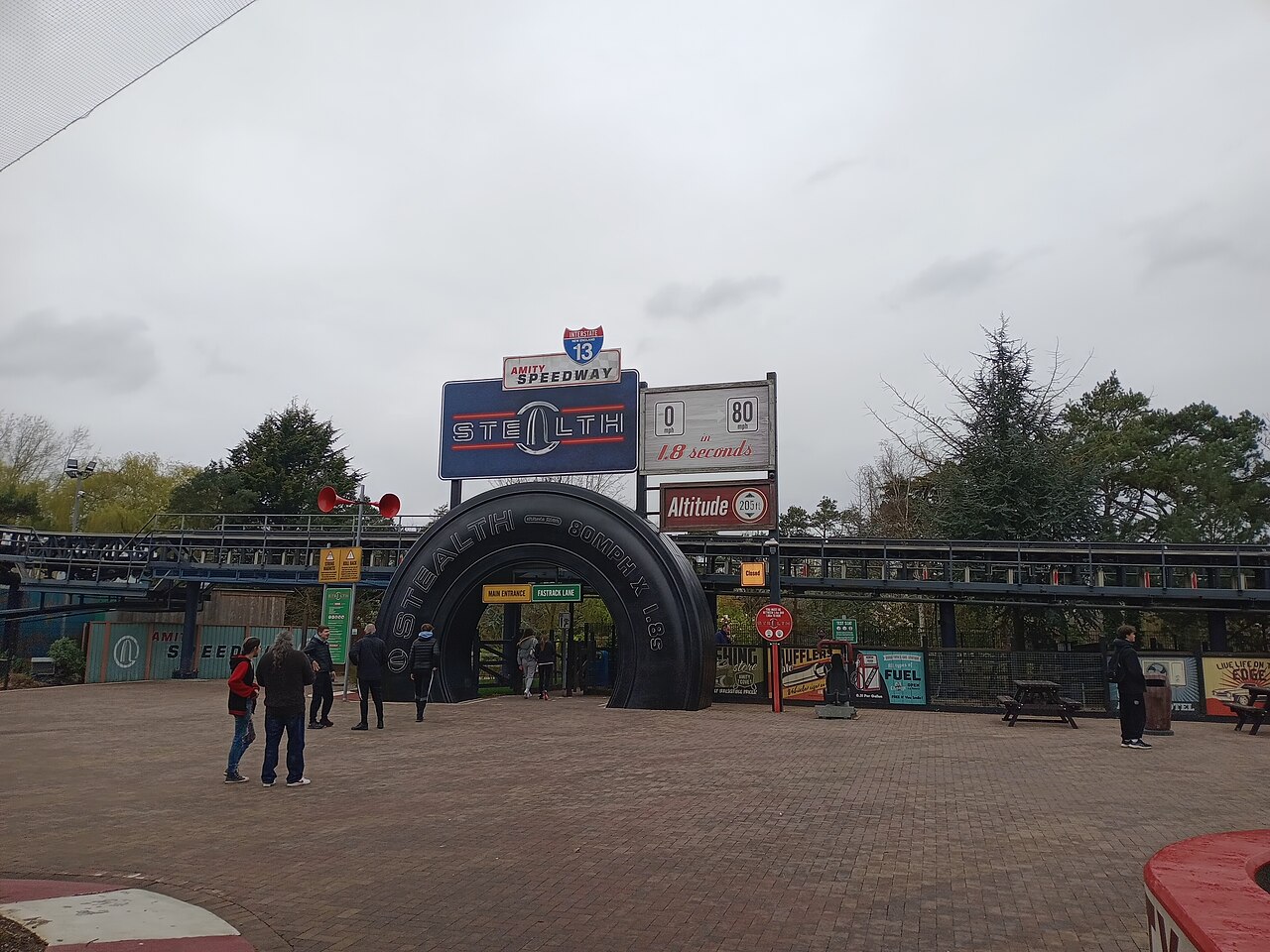 Stealth ride entrance with giant tyre arch and signage at Thorpe Park