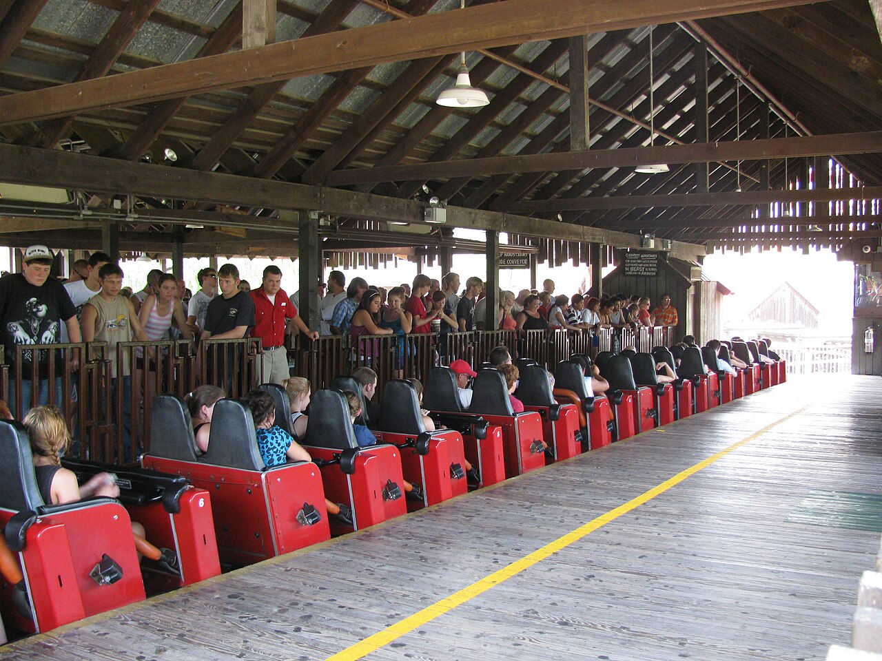 Trains loading in The Beast's covered wooden station at Kings Island