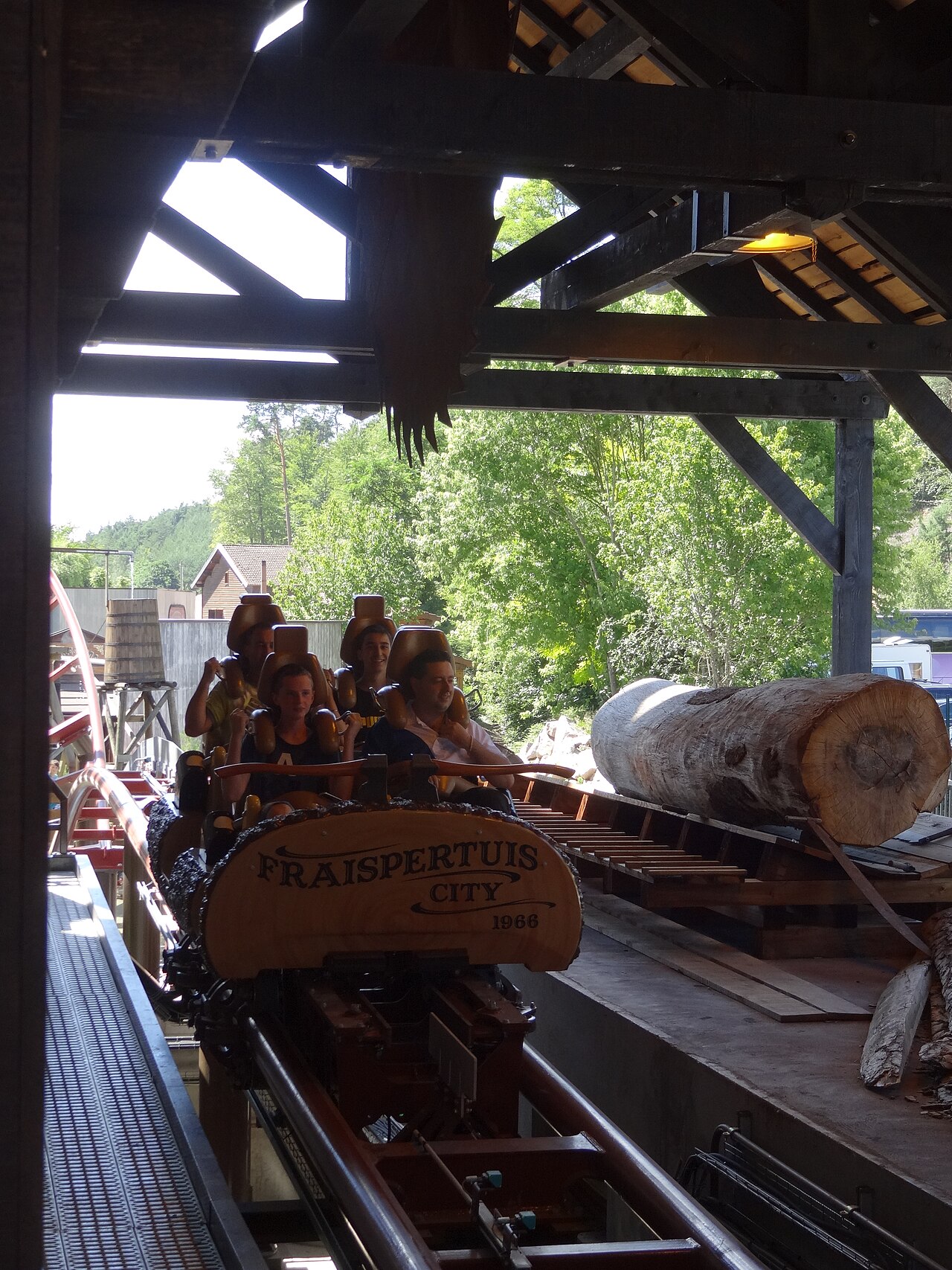 Riders departing the lumberjack-themed Timber Drop station at Fraispertuis-City