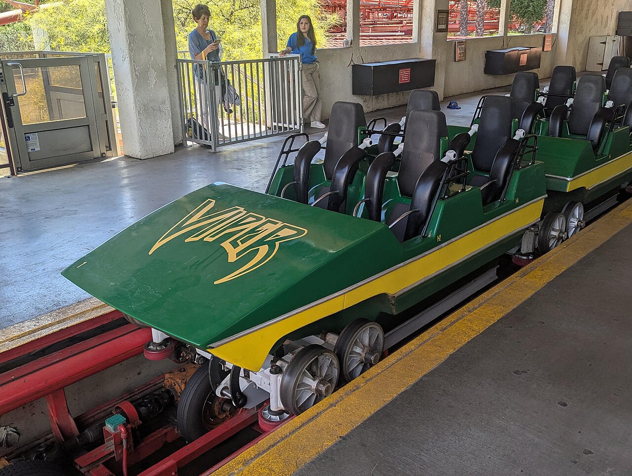 The green Viper lead car with yellow logo sitting in the station at Six Flags Magic Mountain