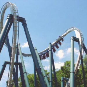 An Alpengeist train twisting through the cobra roll above its teal supports at Busch Gardens Williamsburg