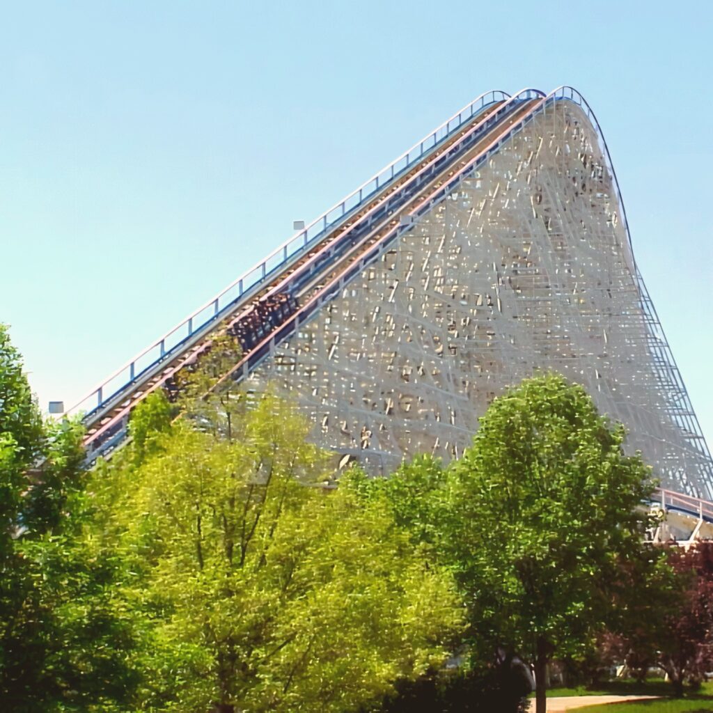 American Eagle at Six Flags Great America: a train climbing the wooden lift hill above the trees