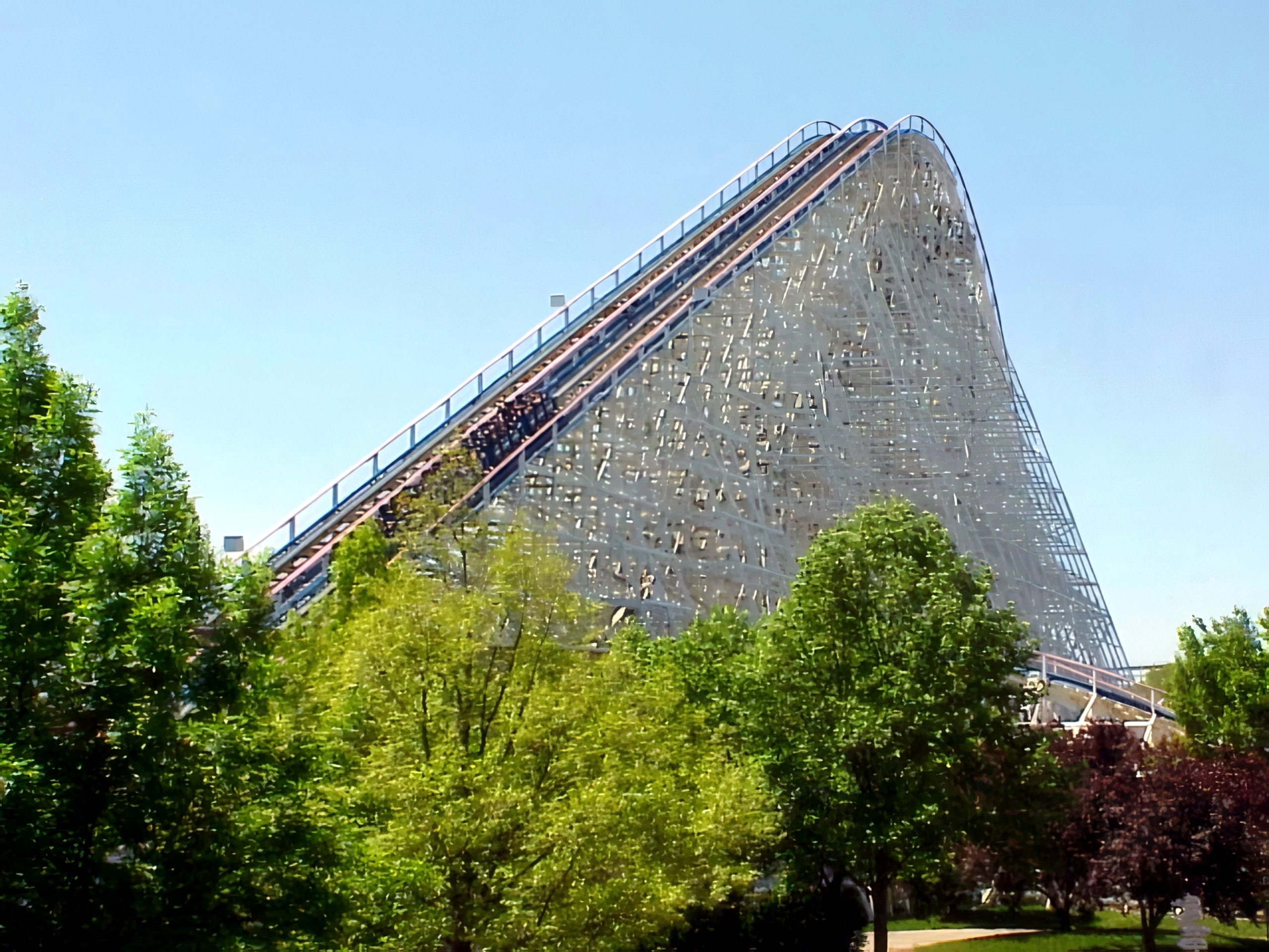 An American Eagle train climbing the lift hill above the trees at Six Flags Great America, May 2001
