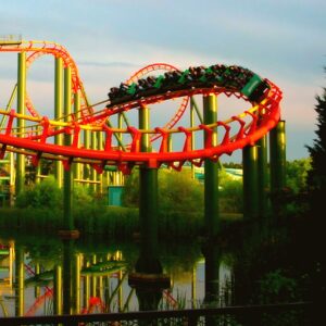 Anaconda at Kings Dominion: a train on the red track above Lake Charles, the loops and supports reflected in the water