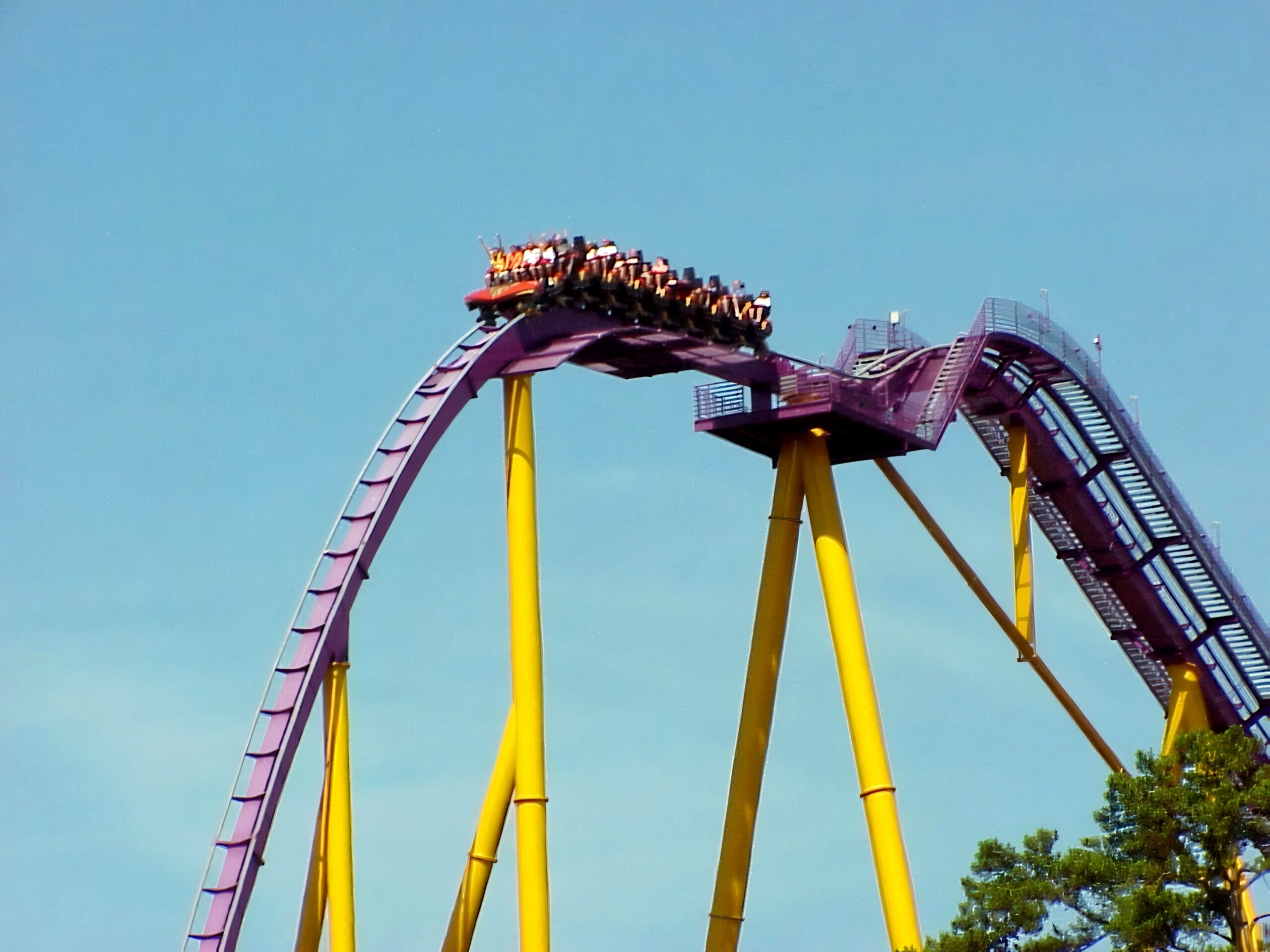 An Apollo's Chariot train over the crest of the lift hill, starting the 210-foot first drop, July 2001