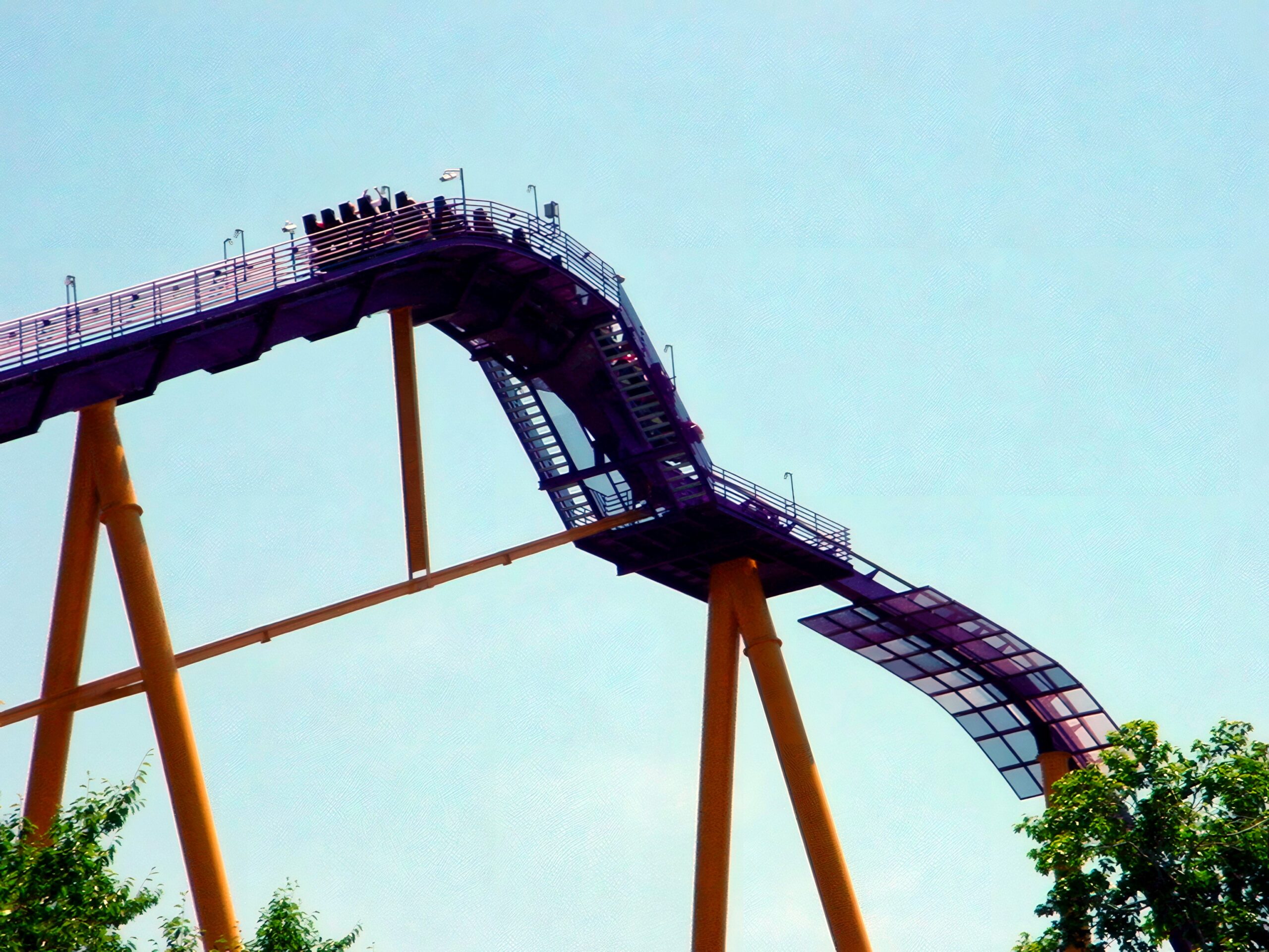 An Apollo's Chariot train at the top of the lift hill against a blue sky, July 2001