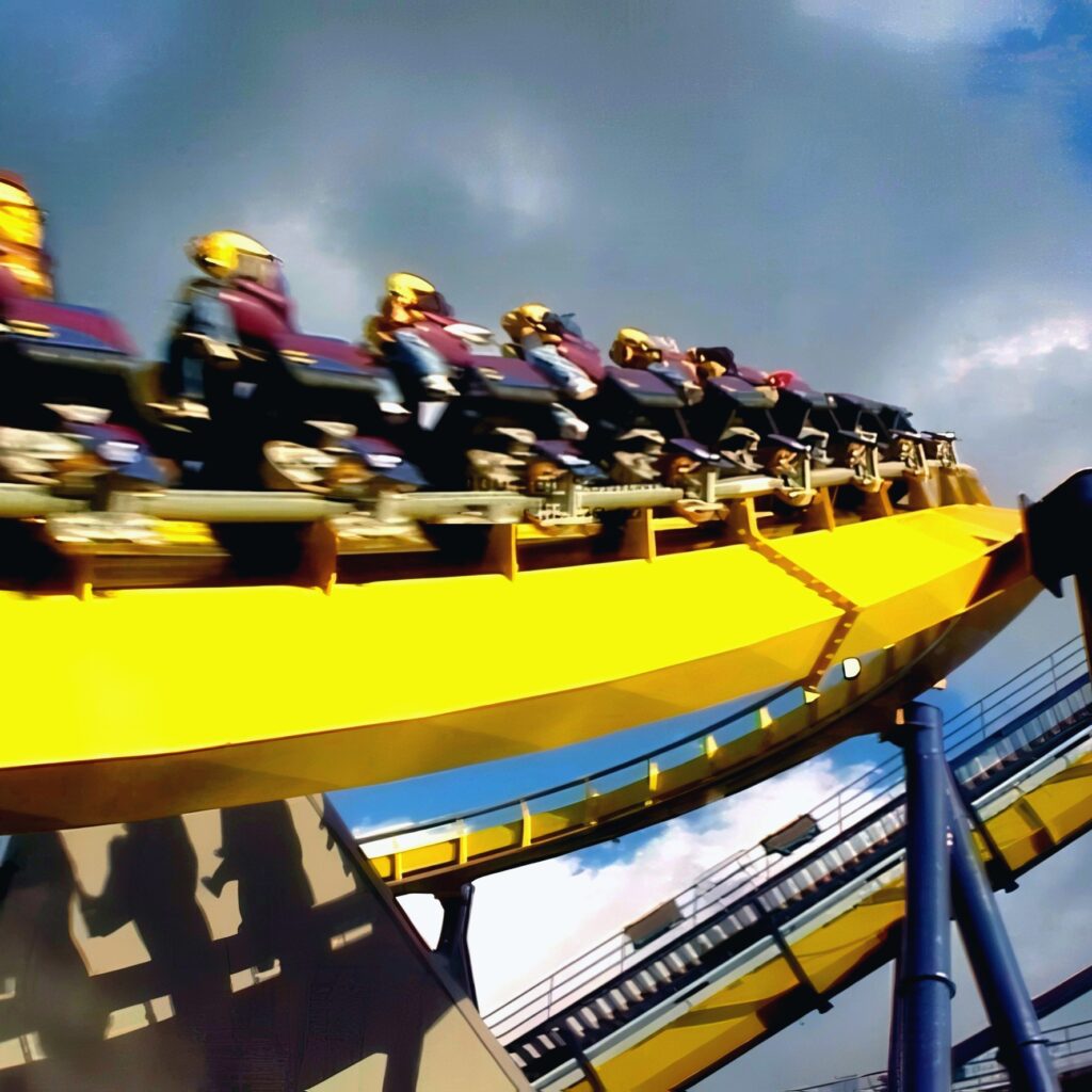 Batman Knight Flight (now Dominator) at Geauga Lake: riders zooming by on the yellow track, shot from the back row