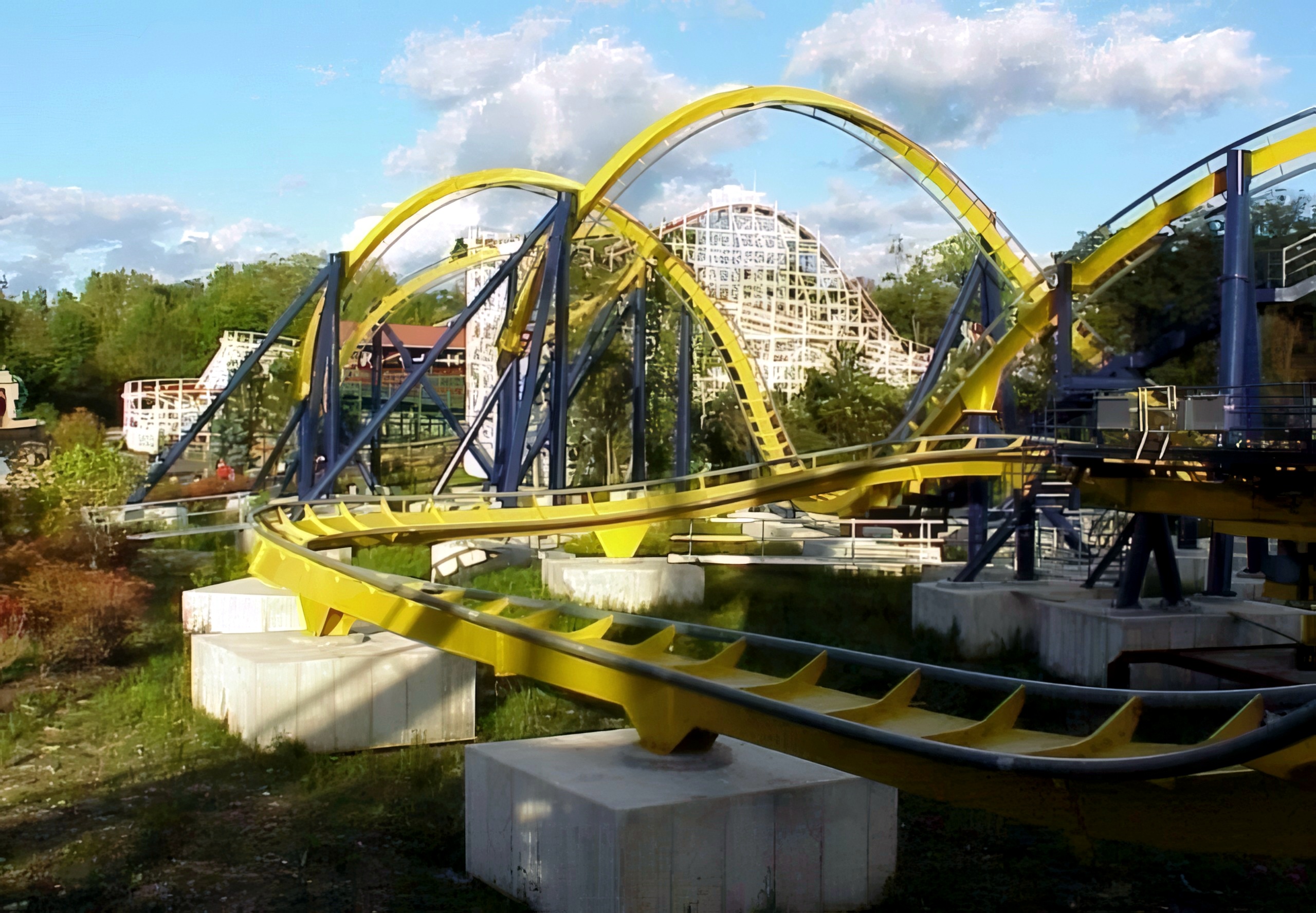 Batman Knight Flight's interlocking corkscrew with Raging Wolf Bobs' white structure behind at Geauga Lake, May 2000